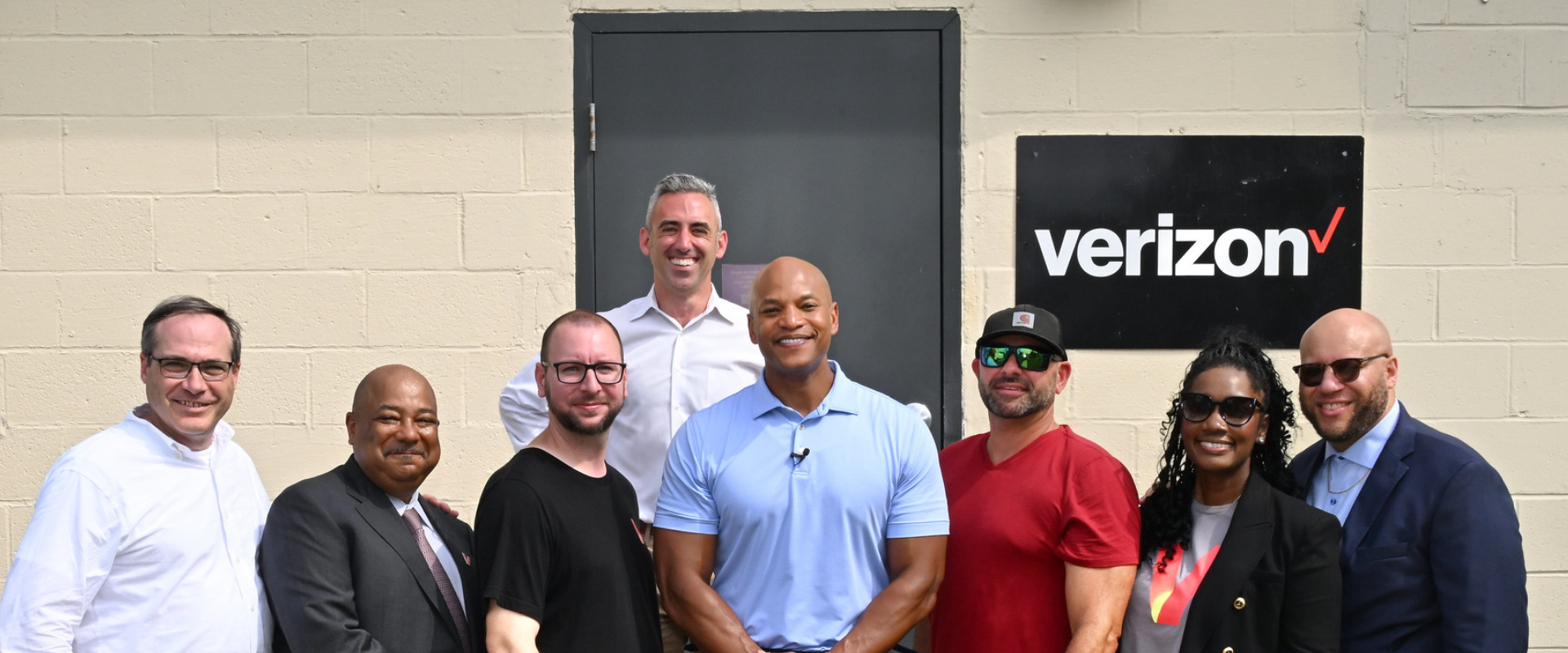 Group Photo with Sec. Day and Governor Wes Moore on Smith Island and a Verizon sign in the background