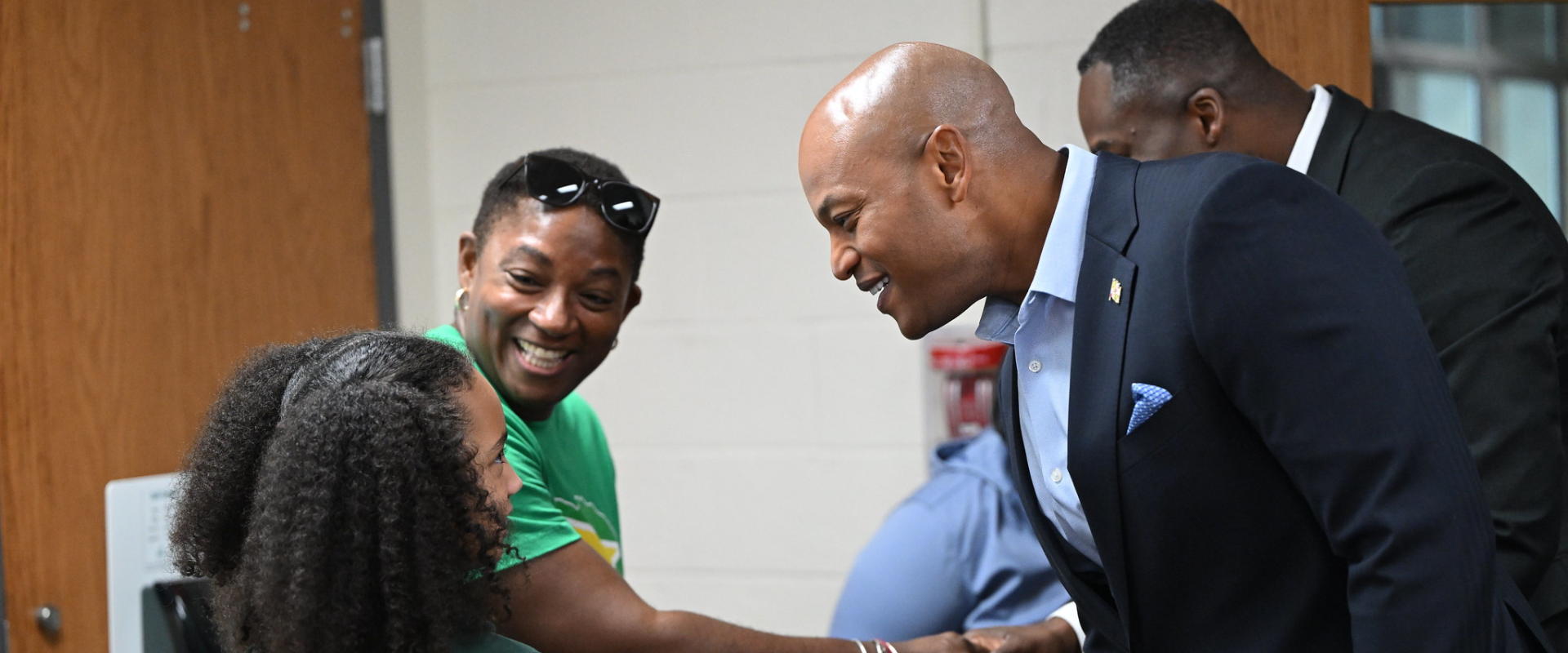 Governor Moore shaking child's hand