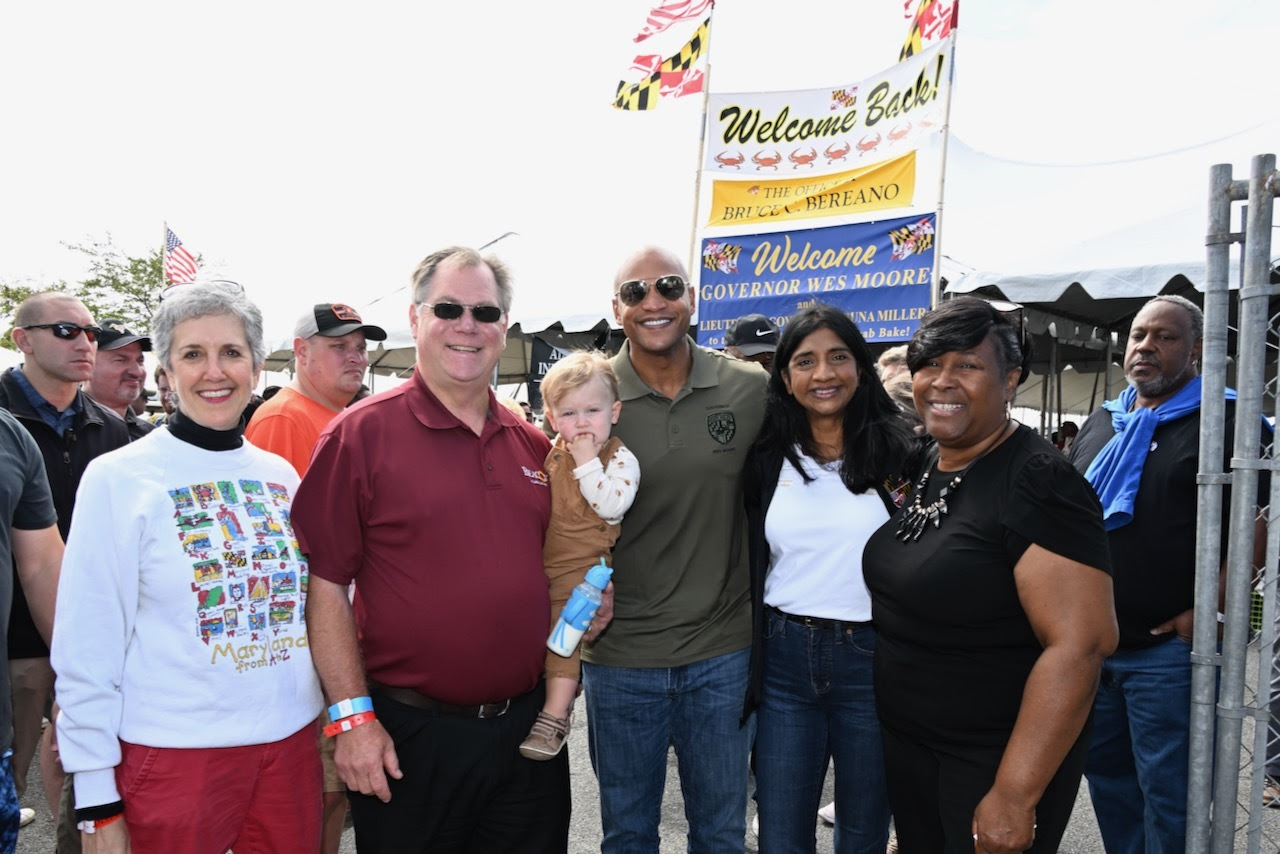 Governor Moore and Lieutenant Governor Miller stand with attendees at the Tawes Crab and Clam Bake