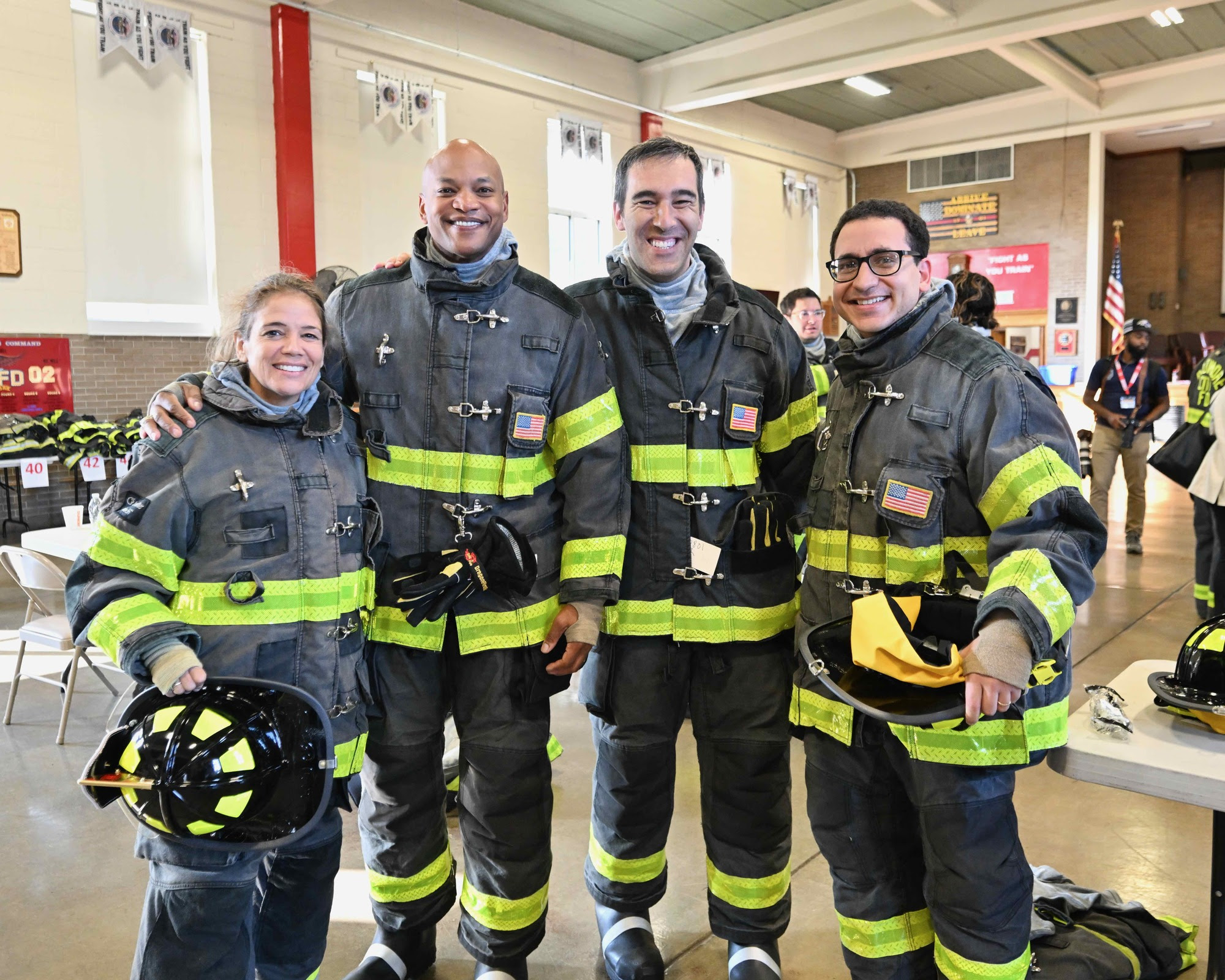 Governor Moore standing with firefighters