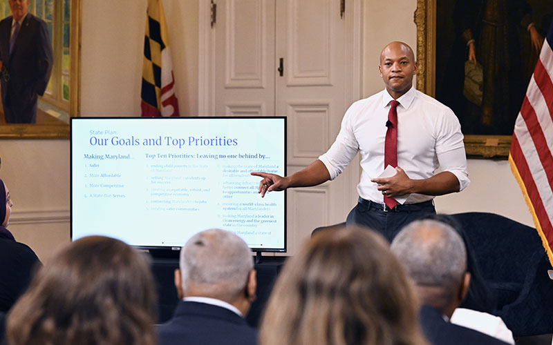 Governor Wes Moore speaks to children viewing books.