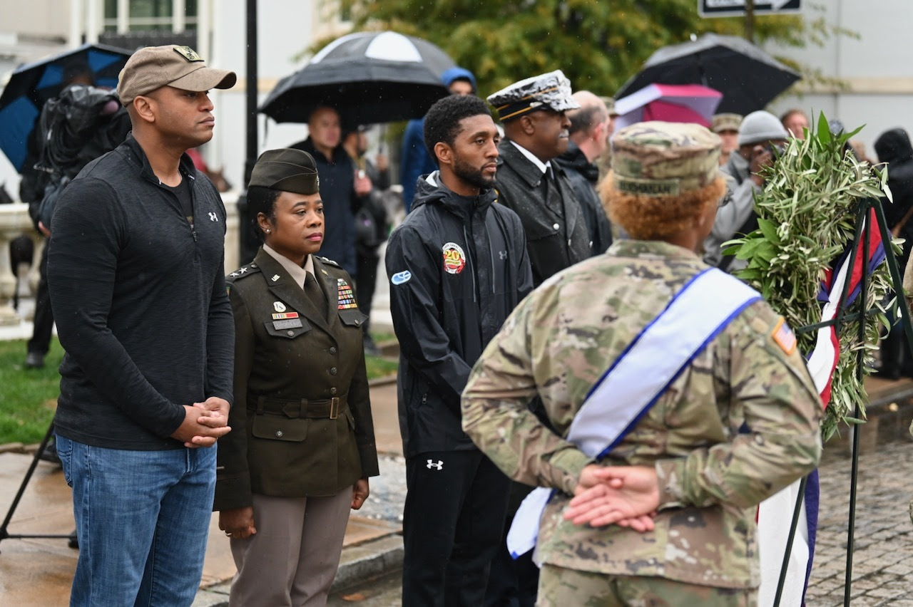 Governor Moore, Adjutant General Birckhead, and Mayor Scott stand in observance of Veterans Day at the Baltimore Veterans Day Parade.