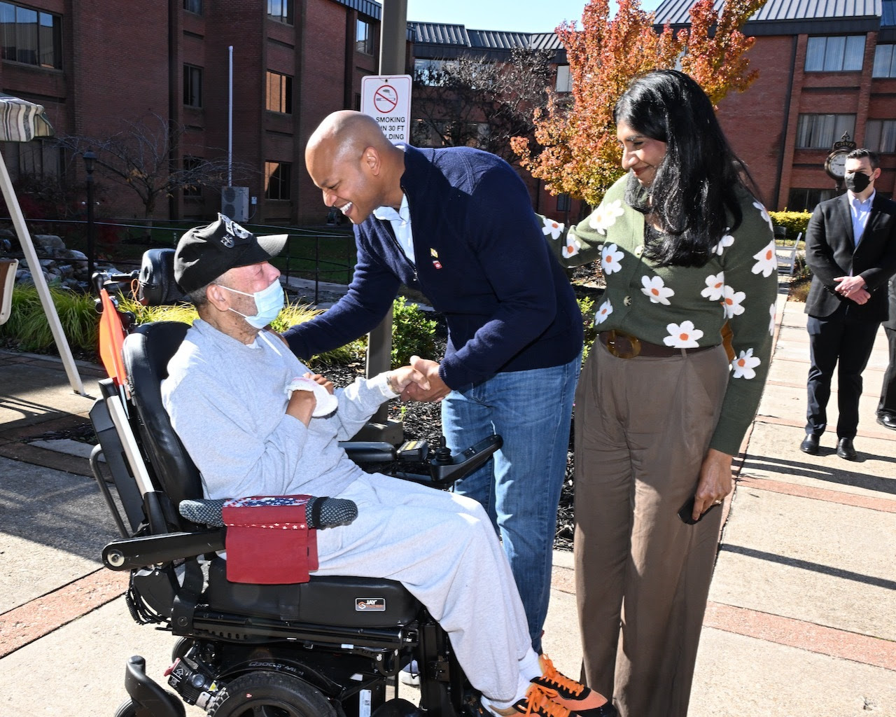 Governor Moore and Lt. Governor Miller greet a resident of the Charlotte Hall Veterans Home.